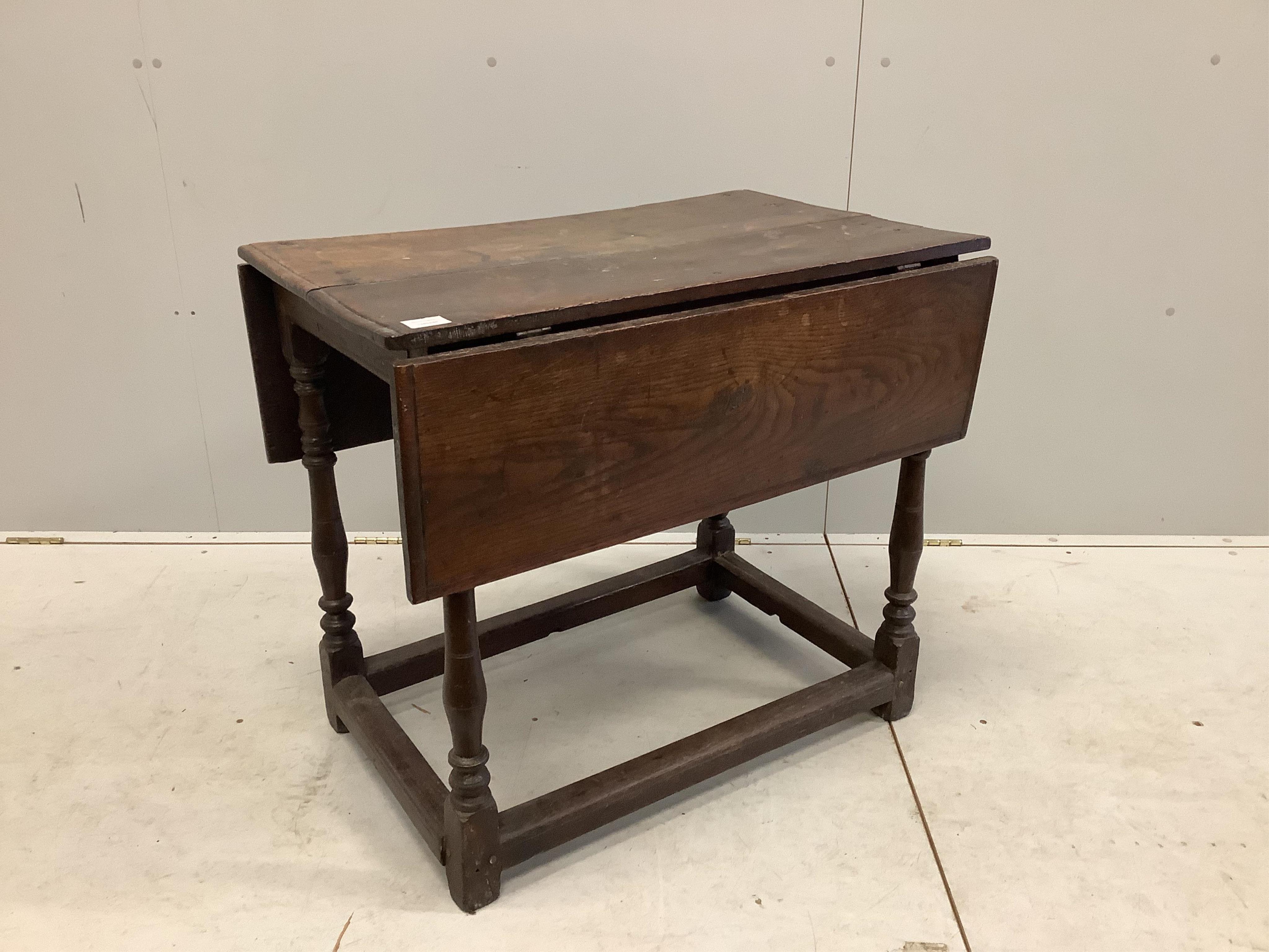 A 17th century rectangular oak drop leaf table on turned legs stretcher rail, label with '165' on the underside and a small white plaque '40', width 82cm, depth 54cm, height 70cm. Condition - poor, one side lacks leaf su